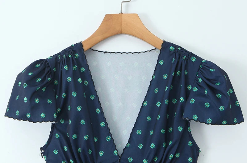 Close-up of the V-neckline and puff sleeves of the mini dress