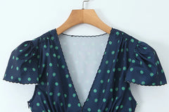 Close-up of the V-neckline and puff sleeves of the mini dress