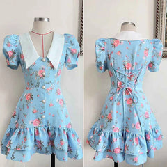 Blue floral dress on a mannequin with a white background