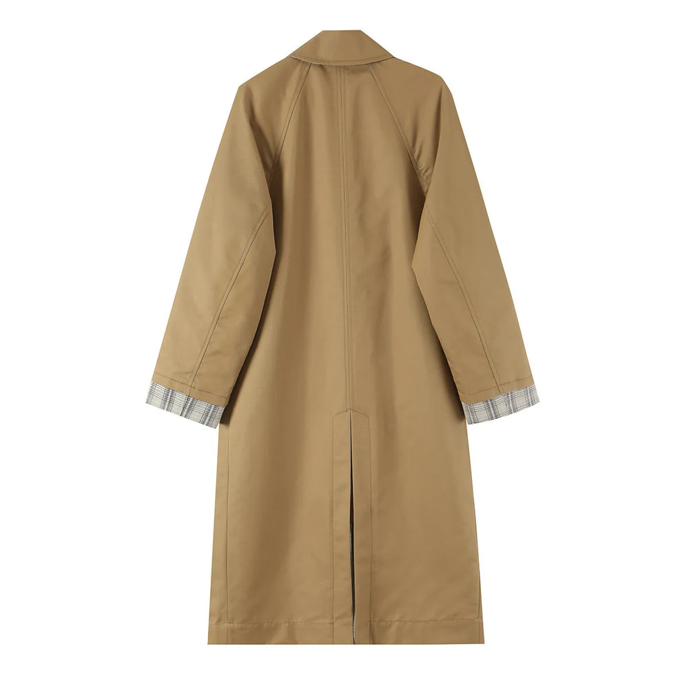 Back view of a reversible coat showing the solid side with a slit.