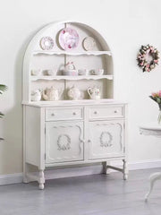 White dresser with decorative items in a room setting