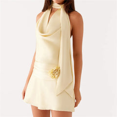 Woman wearing a light yellow dress with a floral detail on a white background