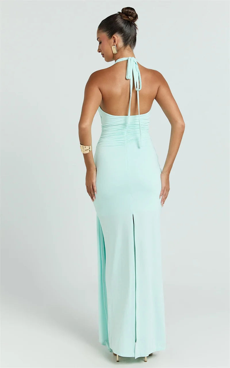 Woman wearing a light blue halter neck gown on a white background
