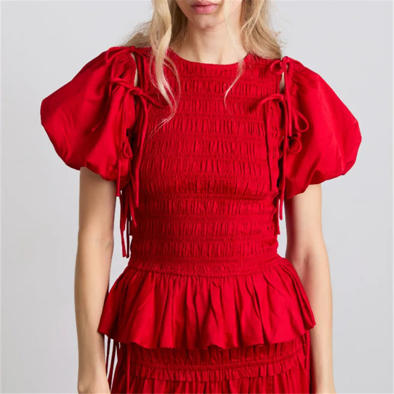 Red dress with puff sleeves on a plain background