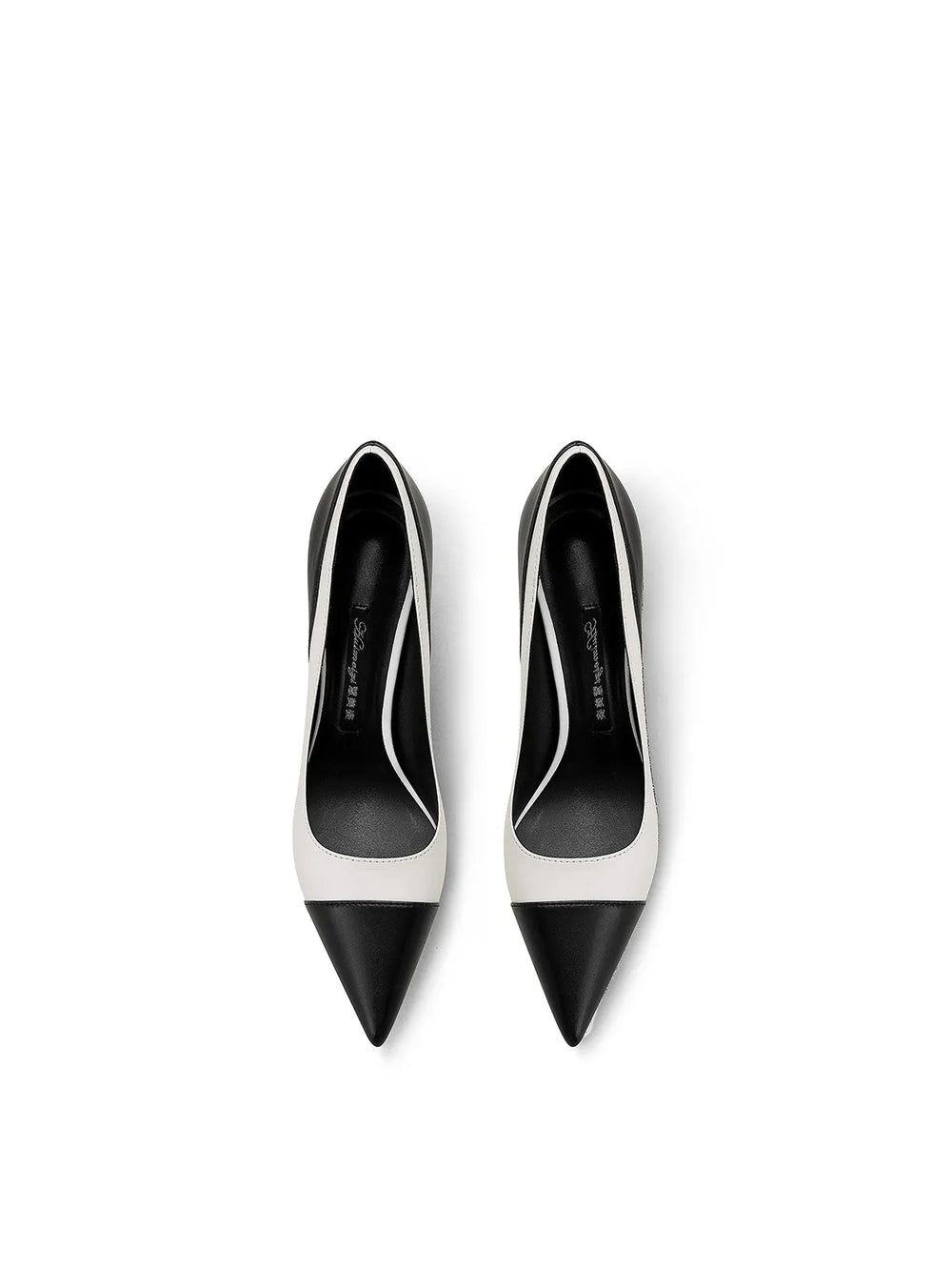Top view of black and white pointed stiletto heel pumps