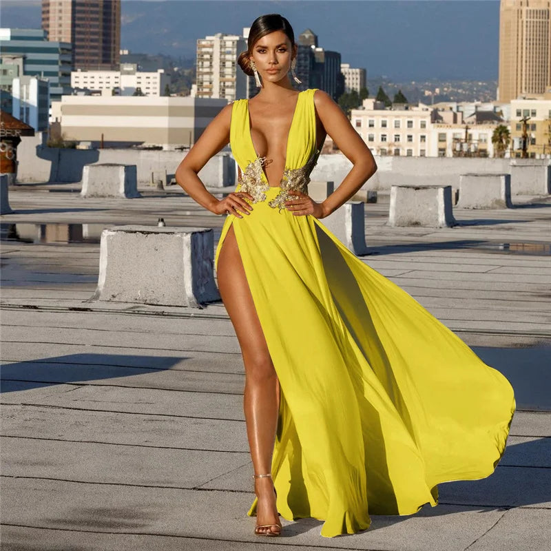 Woman in a yellow evening gown on a rooftop with cityscape background