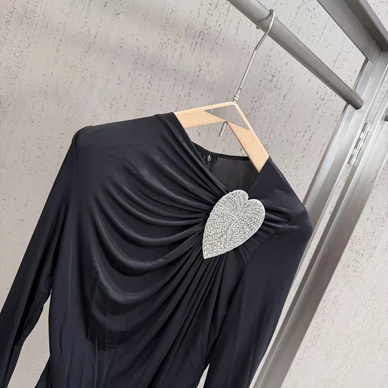 Close-up of heart rhinestone embellishment on black bodysuit