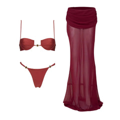 Red bikini and sheer maxi skirt laid out flat.