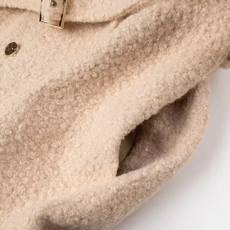 Close-up of a beige textured fabric with a buckle 