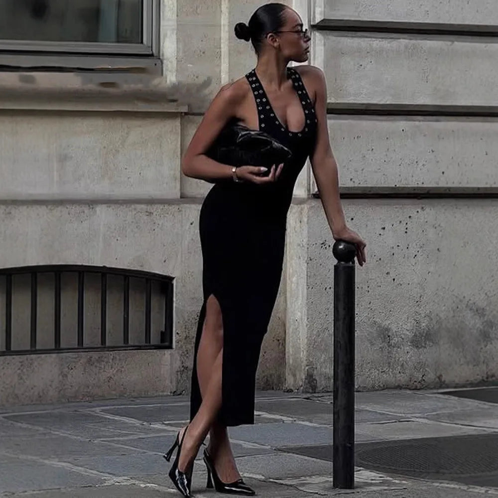 Woman wearing a halter neck studded side cutout maxi dress on a city street
