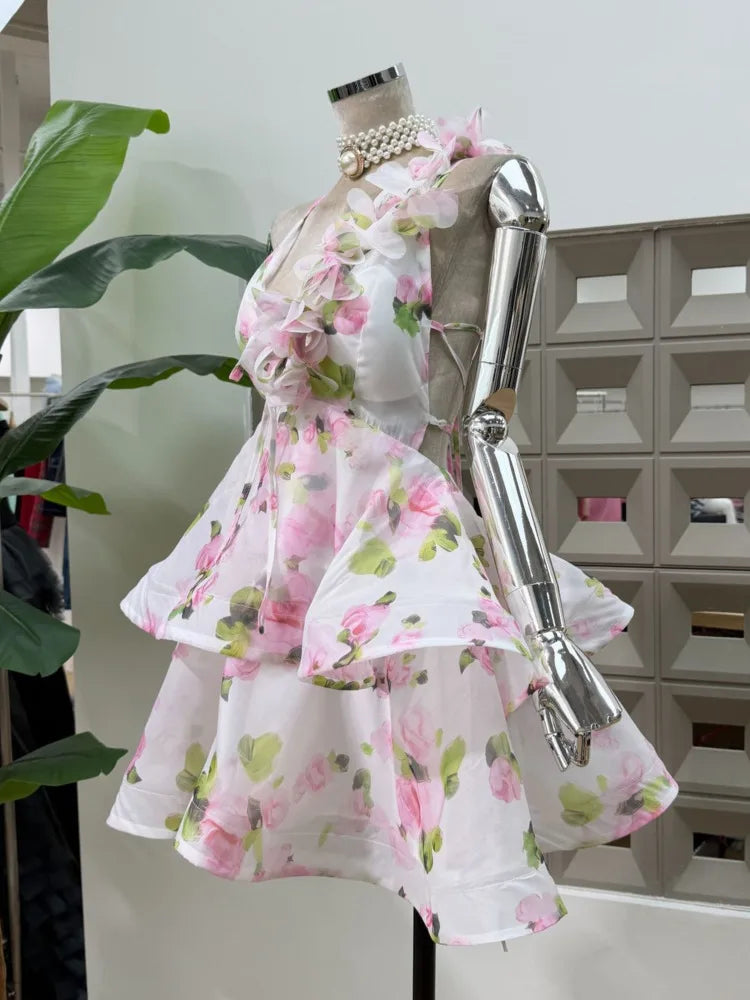 Side view of a floral print halter neck mini dress with layered skirt.
