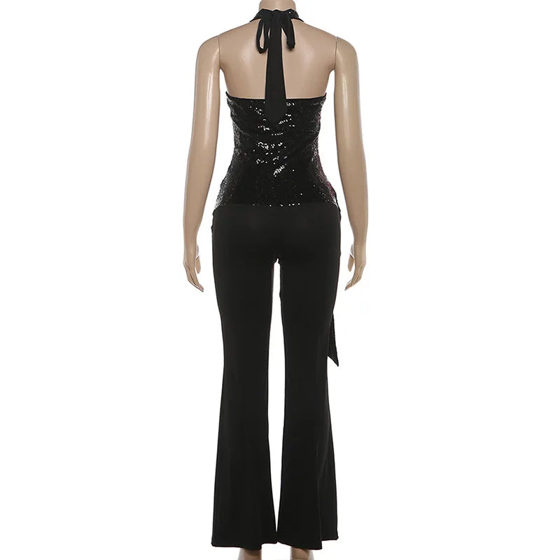 Black sequin top and black pants on a mannequin against a white background