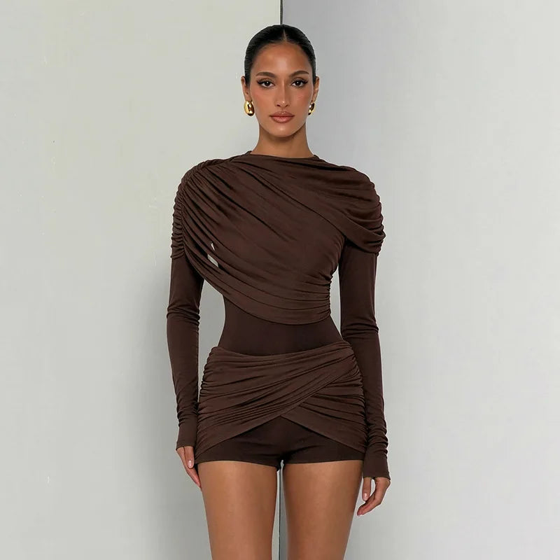 Model wearing a brown draped ruched long sleeve jumpsuit
