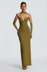 Woman wearing a green strapless gown with matching gloves on a white background