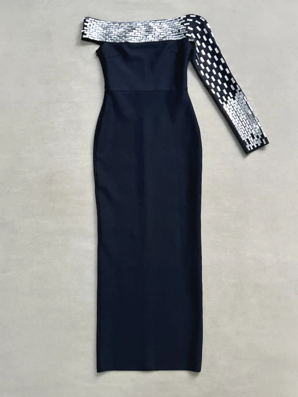 Navy blue off-shoulder dress with sequin detailing on a beige background