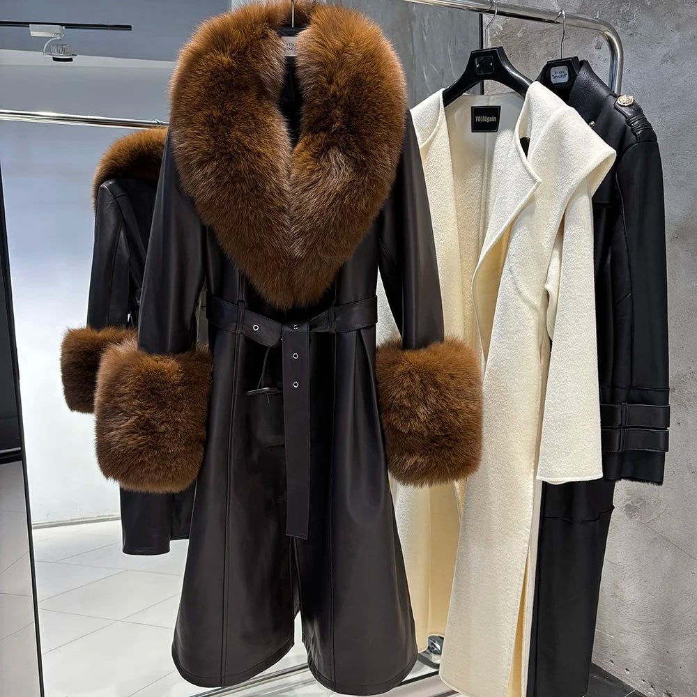 Black coat with fur collar and cuffs hanging on a rack.