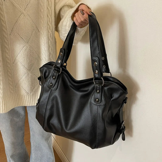 Black tote bag with rivet details and twin top handles