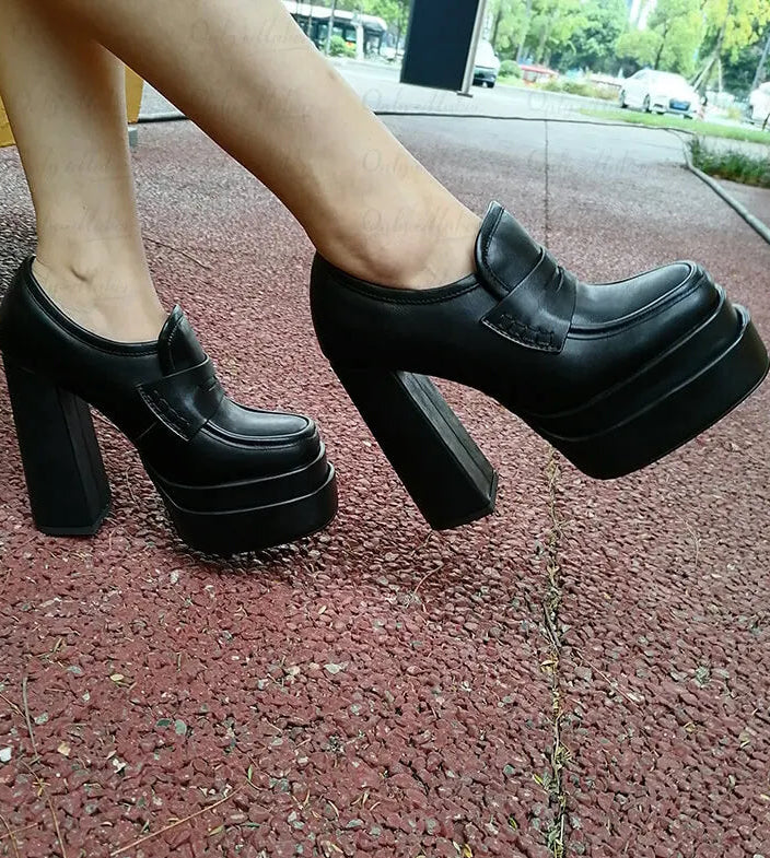 Model wearing chunky platform block heel loafers outdoors