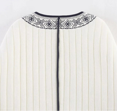 White dress with black embroidery on a light gray background
