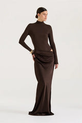 Woman wearing a brown long-sleeve dress on a white background