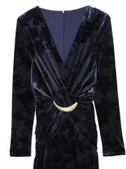 Black velvet dress with a gold belt on a white background