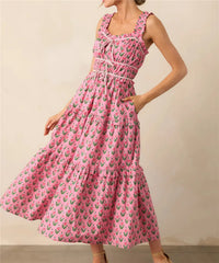 Woman wearing a pink floral dress against a beige background