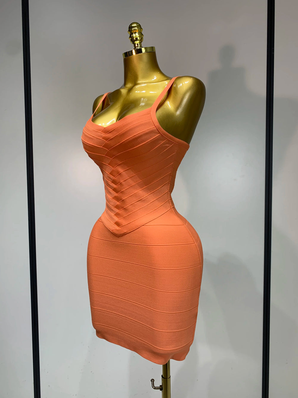 Side view of orange ribbed spaghetti strap mini dress