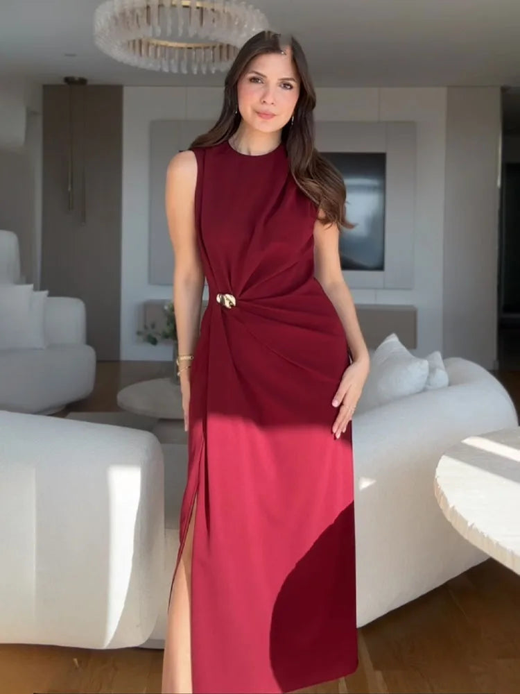 Woman in a red dress standing in a modern living room.