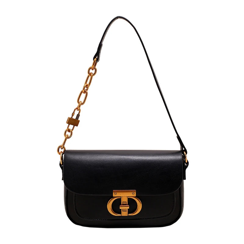 Black handbag with gold chain strap and clasp on a white background