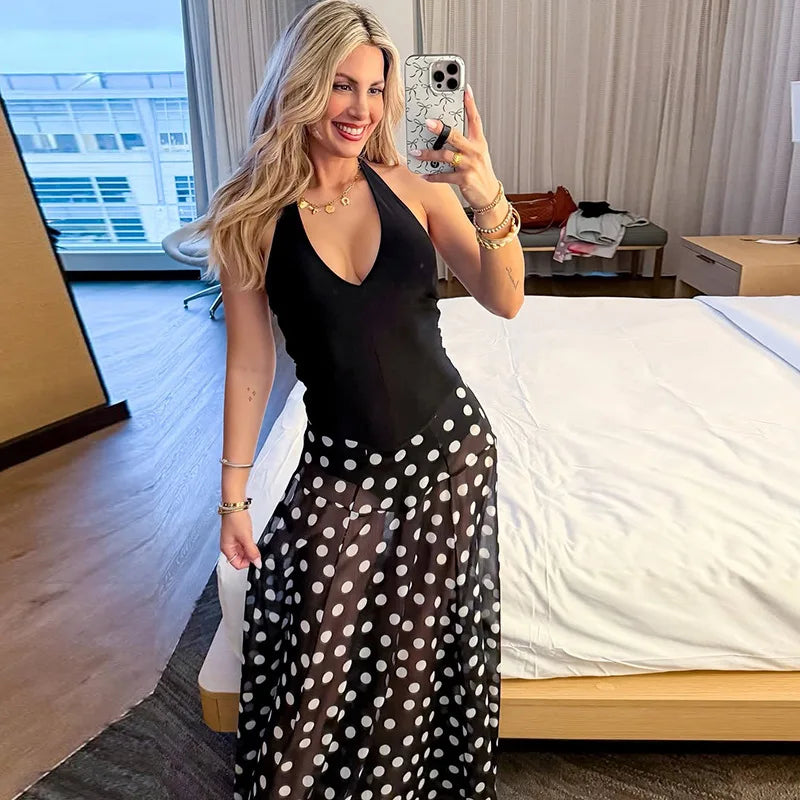Woman wearing a polka dot print halter neck maxi dress