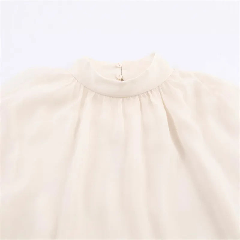 Beige blouse with a collar on a light gray background