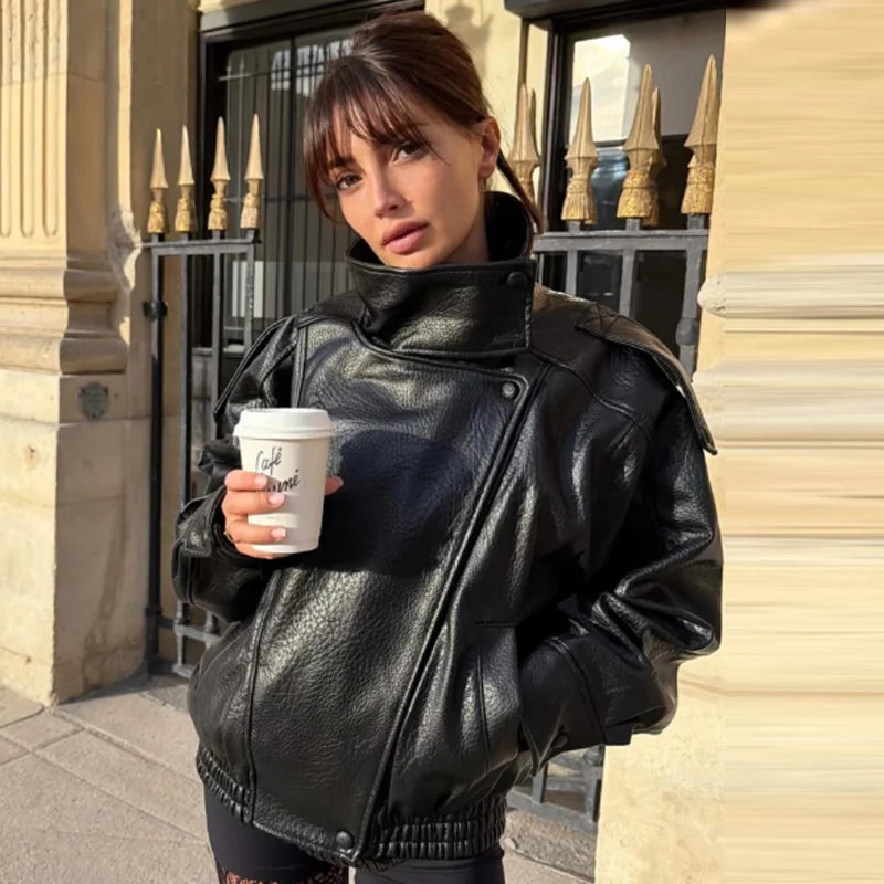 Faux leather mock neck jacket worn by a woman outdoors.