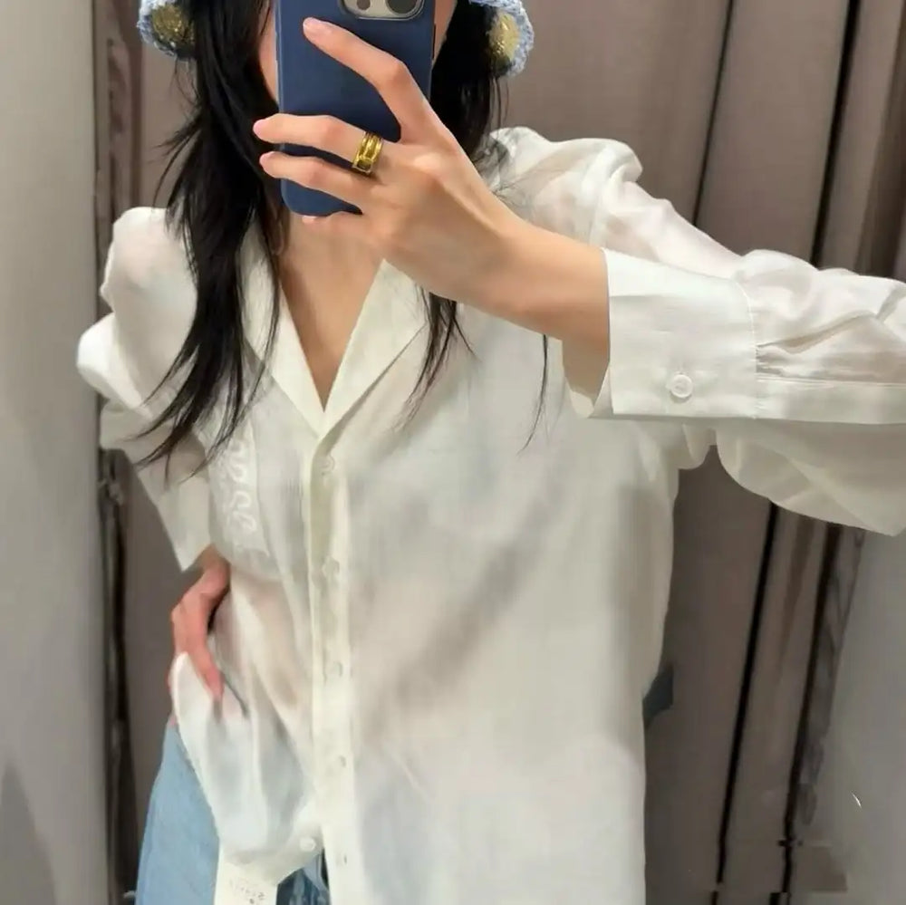 Person wearing a white shirt with a blurred background
