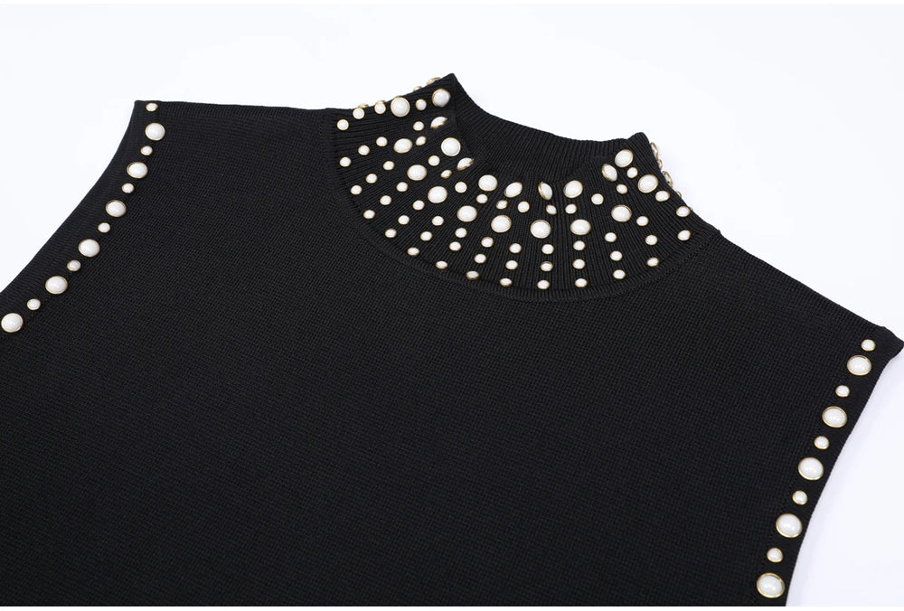 Close-up of studded high collar on black knitted dress