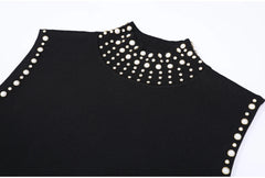 Close-up of studded high collar on black knitted dress