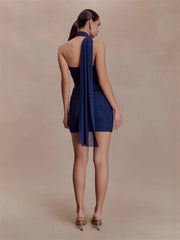Back view of a navy blue crystal embellished mini dress showing the halter strap.