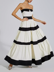 White strapless gown with black ribbons on a gray background