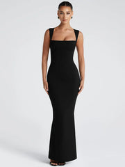 Black evening gown on a model against a white background