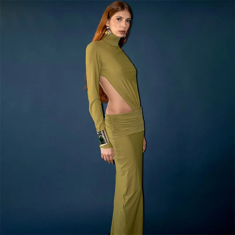 Woman wearing a green outfit with cut-out design on a blue background