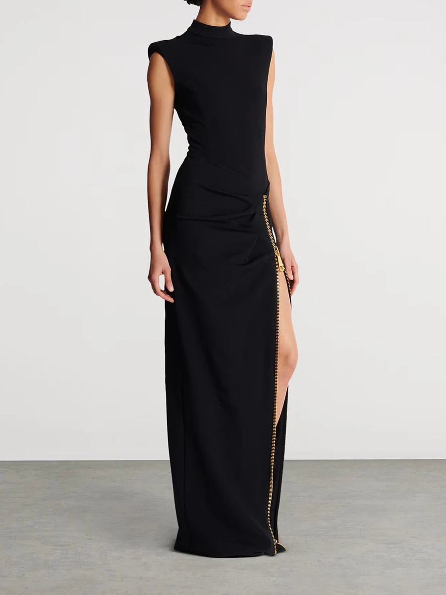 Black evening gown with a high slit on a plain background