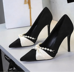 Black pointed toe pumps with bow and pearl detail