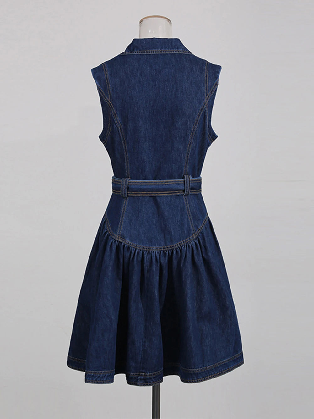 Denim dress on a mannequin against a gray background