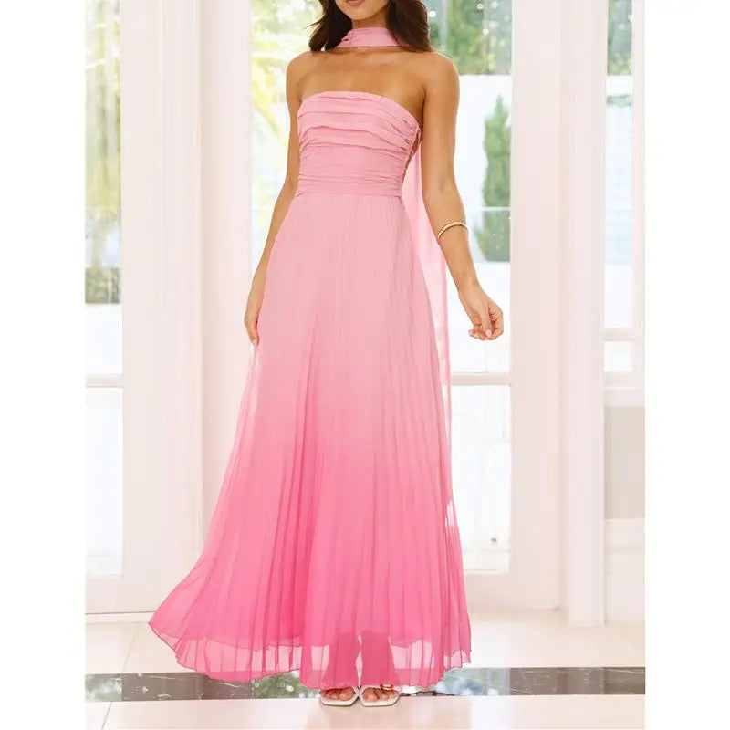 Pink halter neck gown being worn in a bright room with white curtains.