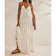 Off-white ruffled halter maxi dress with a straw handbag.