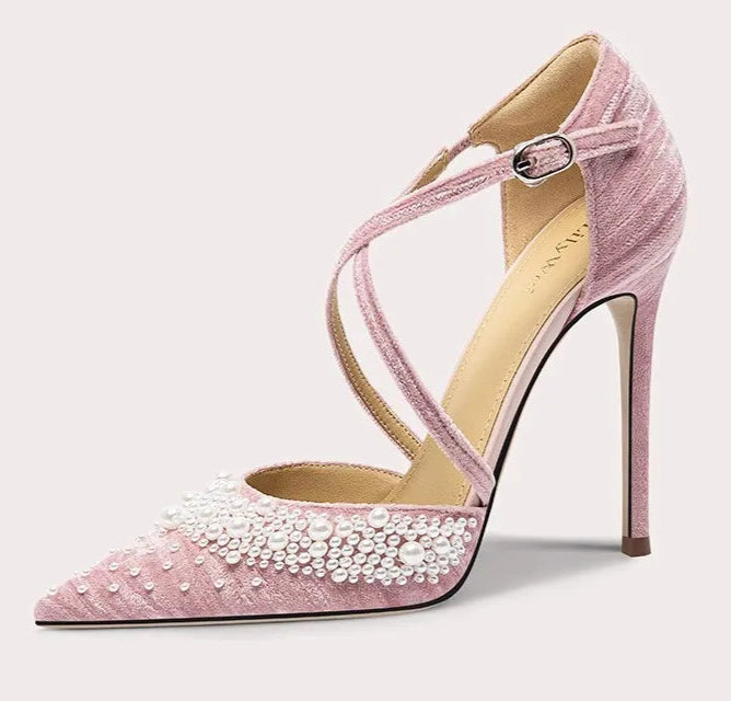 Pink high-heeled shoe with pearl details on a white background