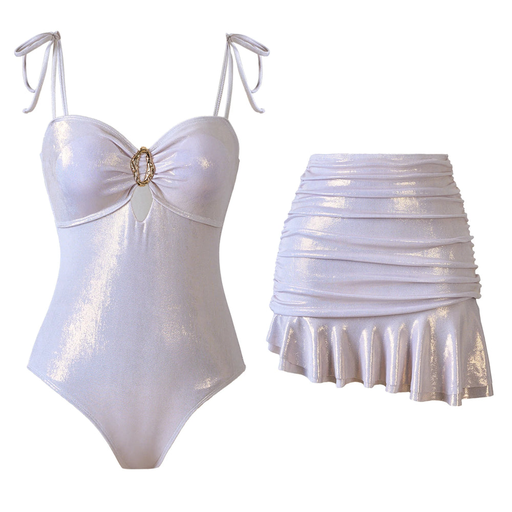 White metallic bikini set with a ruched skirt, featuring a gold accent on the bikini top.