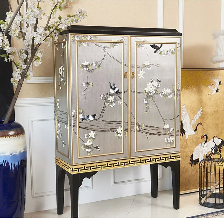 Decorative cabinet with floral and bird designs in a room setting
