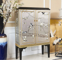 Decorative cabinet with floral and bird designs in a room setting