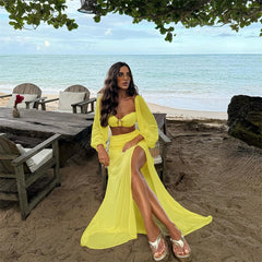 Yellow puff sleeve crop top and high slit maxi skirt set by the ocean
