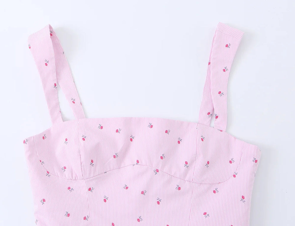 Close-up of the sweetheart neckline and straps of a pink striped floral camisole